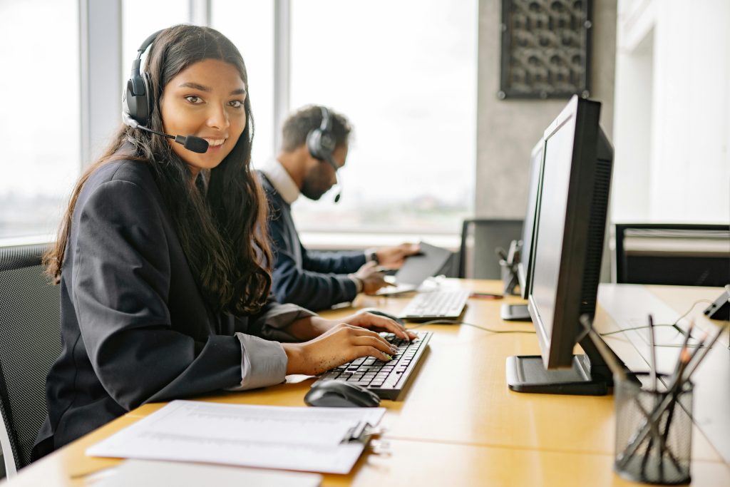 pexels-photo-8867434-8867434 A Smiling Woman Working in a Call Center while Looking at Camera